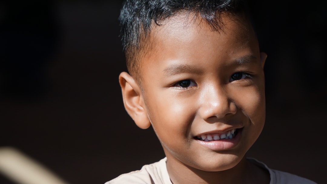 Smiling, curious boy looks at the camera.